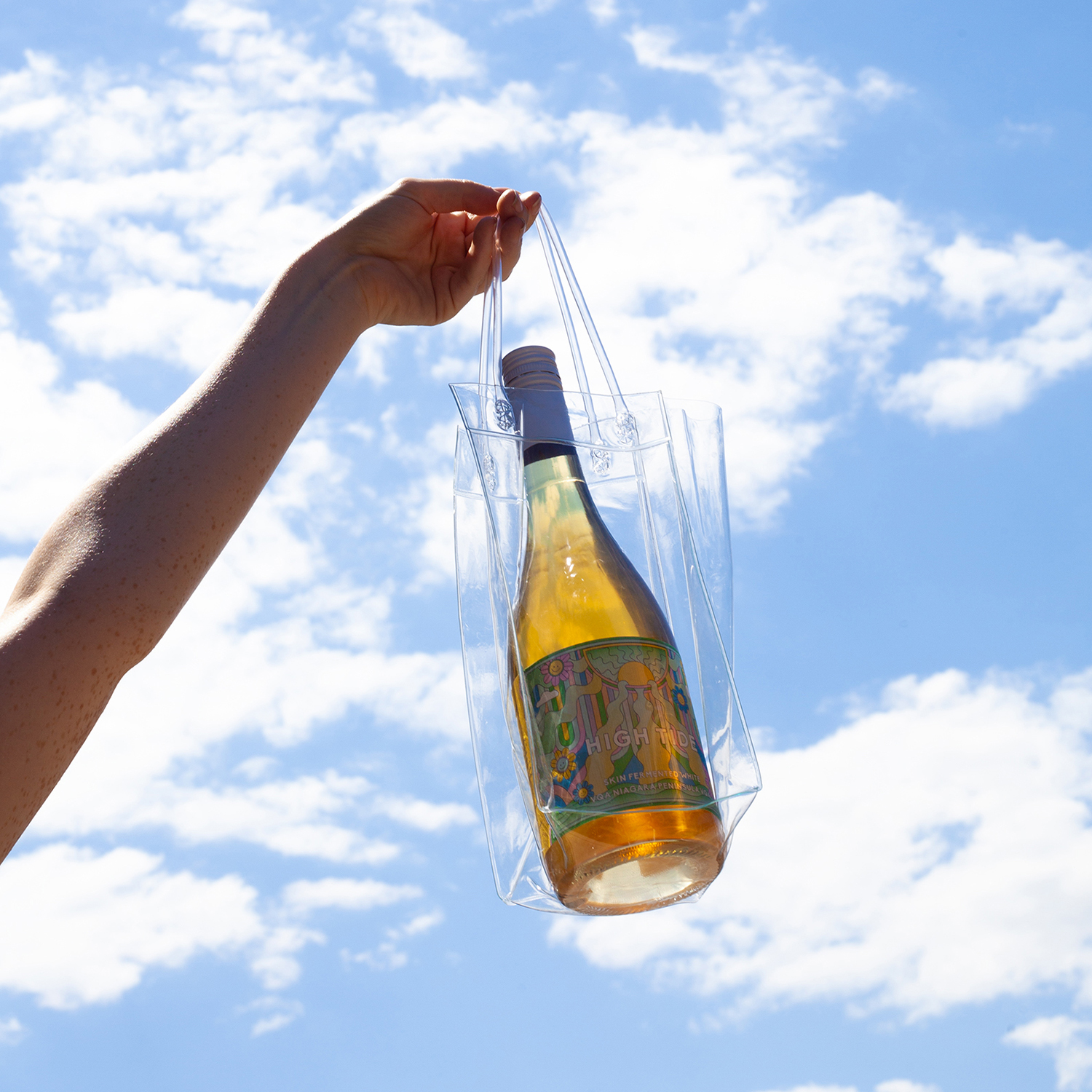 High Tide Wine Label in plastic bag against blue sky with white clouds. Photo by Ray Tran.