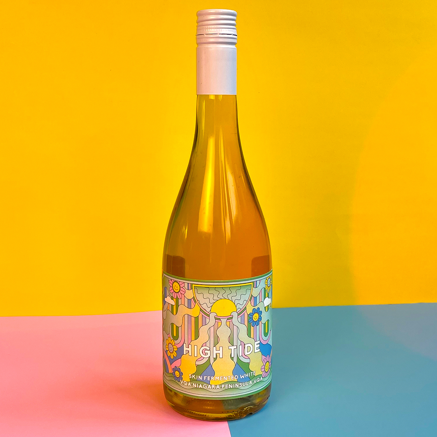 High Tide Wine Label against yellow background and pink and blue table top.Photo by Ray Tran.